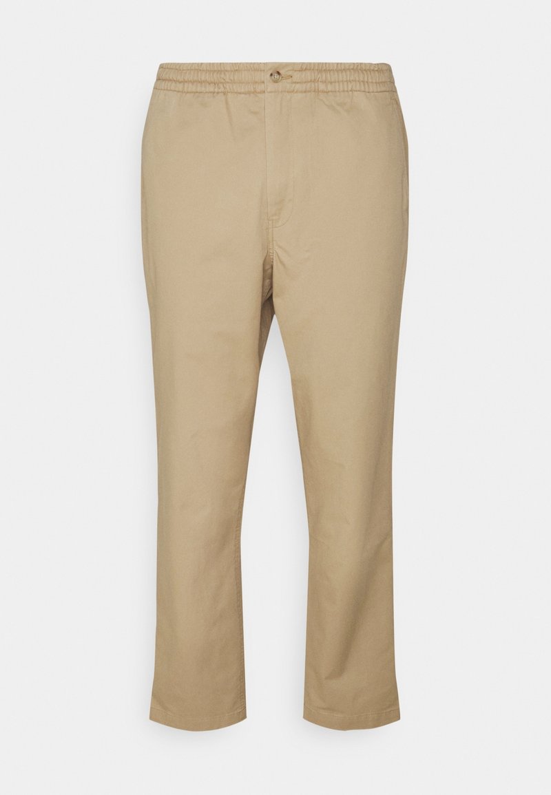 Beiga bomullsbyxor med elastisk midja och knappstängning, med raka ben och minimala sömnadsdetaljer.