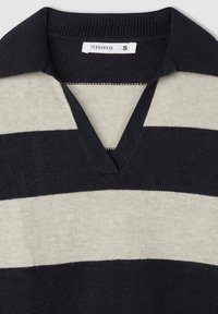 Czarny i kremowy sweter w paski z dekoltem w serek i krótkim kołnierzykiem. Wykonany z miękkiego materiału, z teksturowanym wykończeniem i metką.