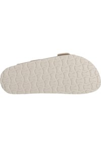 Sula av sko med en texturerad gummiyta, med ett vågigt geometriskt mönster i beige. Rundad tå och lätt klackhöjd.