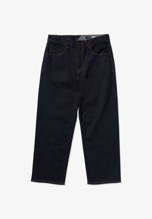 Jeans in denim blu scuro a vestibilità ampia con cuciture visibili, quattro tasche e chiusura con bottone. Il tessuto ha una superficie liscia.