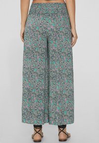 Kwiatowe spodnie palazzo wykonane z lekkiego materiału. Posiadają skomplikowany wzór paisley w kolorze turkusowym, różowym i szarym. Szerokie nogawki.