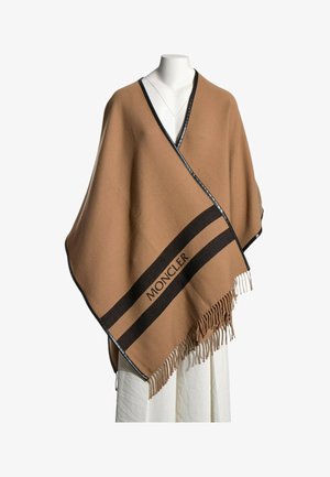 Kamelfarvet uldponcho med sort kant, frynser og sorte striber med "MONCLER" logoet foran.