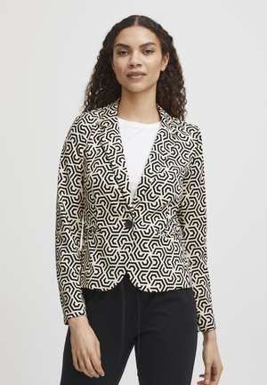 Blazer s geometrickým vzorem v černé a krémové barvě, s výstřihem do "V", zapínáním na jeden knoflík a přiléhavým střihem. Vyrobeno z texturované tkaniny.