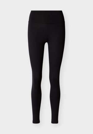 Čierne legíny z pružnej látky, s vysokým pásom a priliehavým strihom. Hladká textúra, bez vzorov alebo ozdôb.