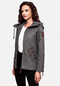 Gray waterproof jacket with a hood, featuring a dotted pattern, zipper pockets, and brown leather accents. Smooth texture and practical design.
