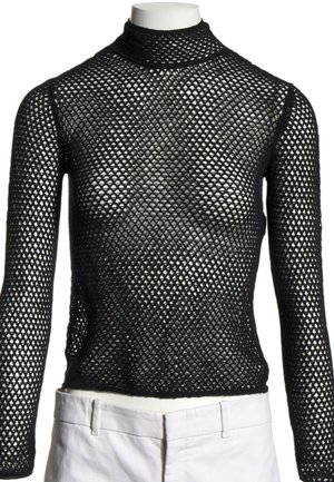 Haut noir en maille à manches longues avec col montant présenté sur un mannequin, associé à un pantalon blanc à la taille.
