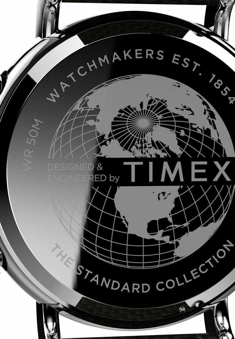 Dos d'une montre Timex présentant un design de globe avec le texte : « Horlogers depuis 1854 », « WR 50M » et « La collection standard ».}}