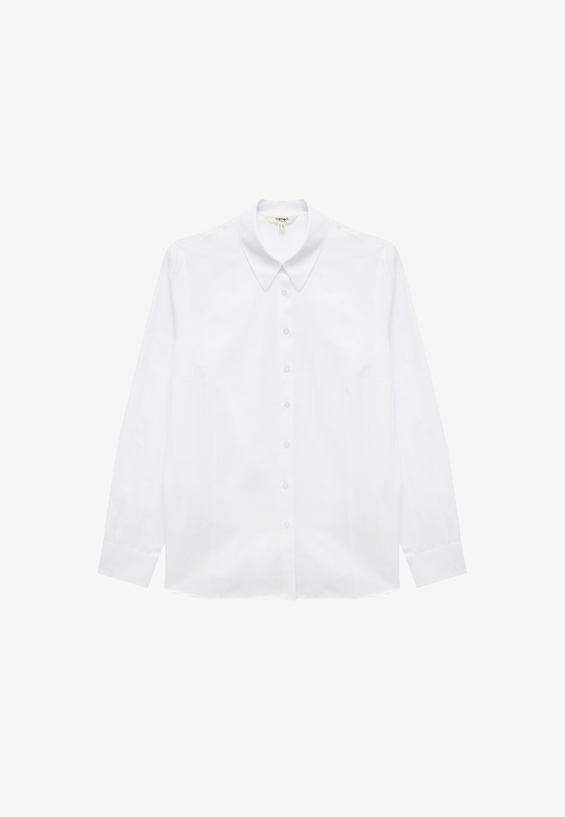 White long-sleeve shirt made of cotton, featuring a pointed collar, front button closure, and straight-cut hem. Smooth texture, no patterns.