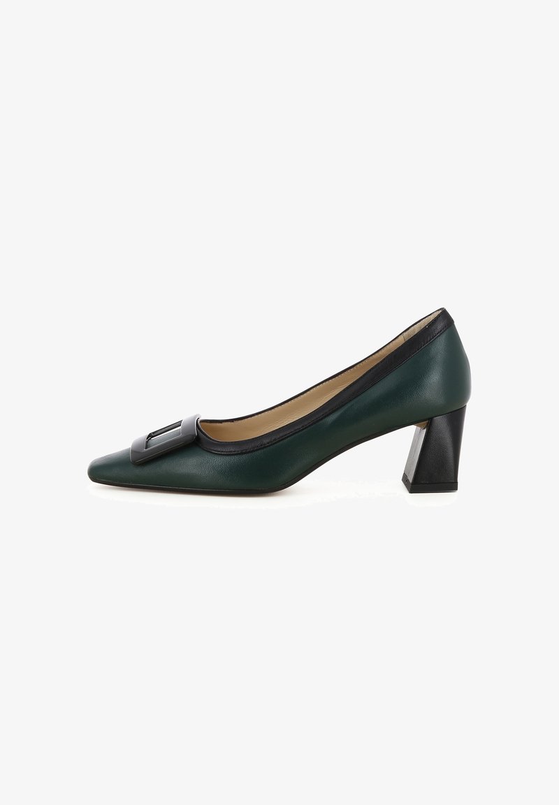 Escarpin en cuir vert avec un bout pointu et un détail noir à l'avant. Talon noir épais offrant de la stabilité. Texture lisse dans l'ensemble.