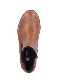 Bottines en cuir brun avec une finition lisse, des panneaux latéraux élastiques et un détail de fermeture éclair. Elles ont une semelle intérieure rembourrée et une semelle en caoutchouc.