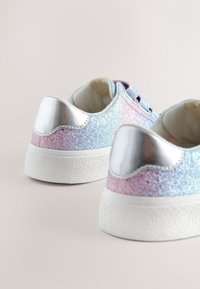 Low-top sneakers with glittery pastel blue, pink, and purple uppers and silver heel panels on white rubber soles.