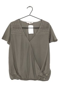 Olive green short-sleeve blouse with lace detailing on shoulders, deep V-neck, and gathered bottom hem. Tag attached.