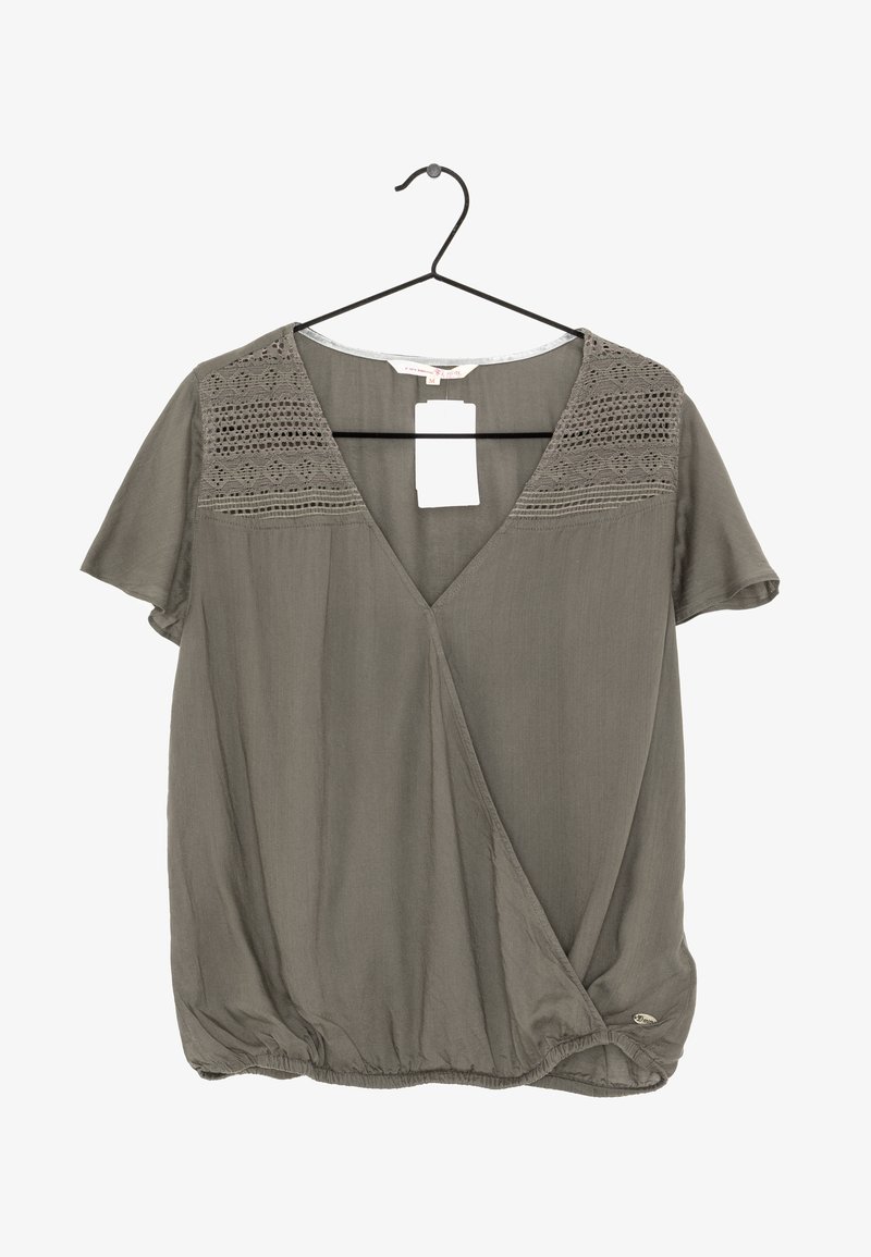Olive green short-sleeve blouse with lace detailing on shoulders, deep V-neck, and gathered bottom hem. Tag attached.