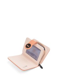 Peach leather wallet with a snap closure, transparent ID window, card slots, and a smooth interior, featuring subtle polka dot texture.