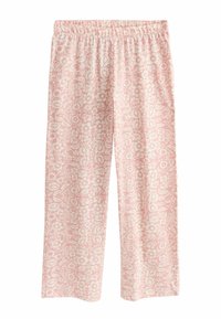 Pantalon ample rose avec une ceinture élastique, présentant un motif floral blanc couvrant l'ensemble.