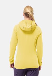 Geel langemouwig hoodie met een zachte, gladde textuur en een aangesnoerde, gestructureerde capuchon. Heeft een aangesloten ontwerp en naaddetails.