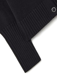 Schwarzer Strickpullover mit gerippten Bündchen, ausgestattet mit einem dekorativen Knopf mit Strasssteinen. Weicher Stoff und rechteckige Form.