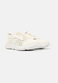 Sneakers beige chiaro con tomaia in mesh, dettagli testurizzati e suole in gomma bianca. Presentano lacci e perforazioni per la traspirabilità.