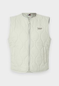 Vaaleanharmaa tikattu liivi, jossa pyöreä kaula-aukko, etuvetoketju ja sivutaskut. Varustettu ruskealla "Tommy Jeans" -logolla kirjailtuna.