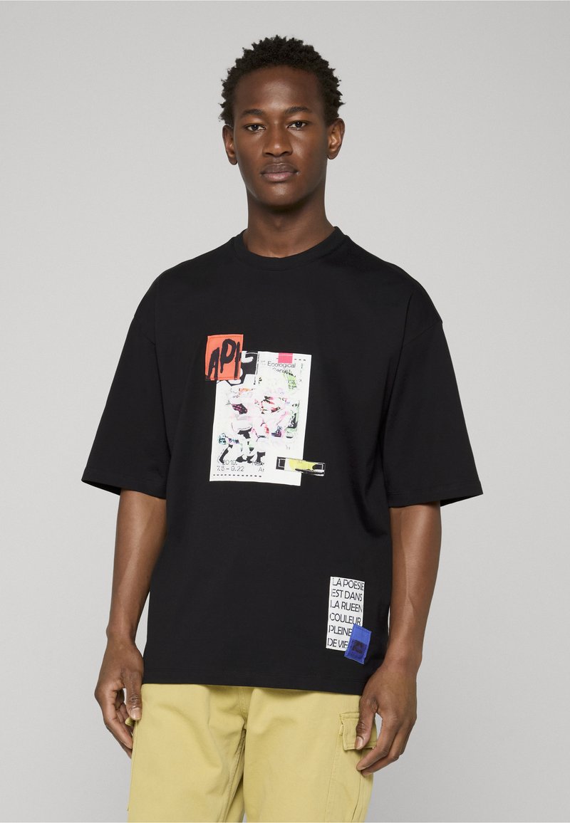 T-shirt noir à manches courtes avec une impression graphique colorée et des détails en patch. Confectionné en coton avec une coupe décontractée.