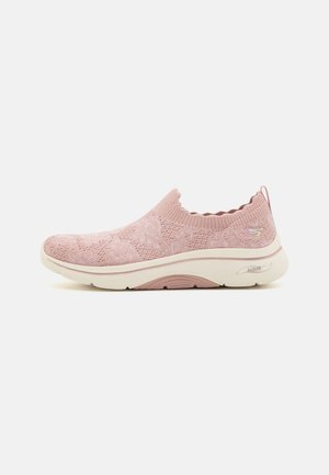 Pink slip-on sneaker with textured knit upper, scalloped collar, and cushioned outsole featuring white and soft pink accents.