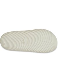 Semelle de chaussure blanche flexible avec des rainures horizontales et des rainures rondes, présentant un logo "G" et des détails de taille embossés sur la surface.