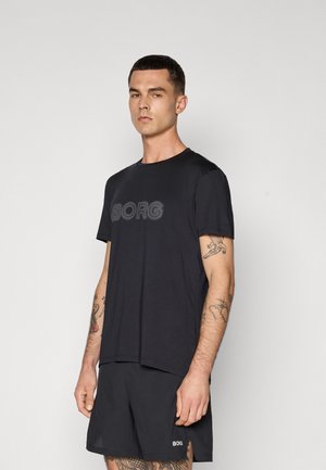 T-shirt noir à manches courtes avec le logo "BORG" sur la poitrine, associé à un short noir assorti. Le tissu semble lisse, la coupe est décontractée.