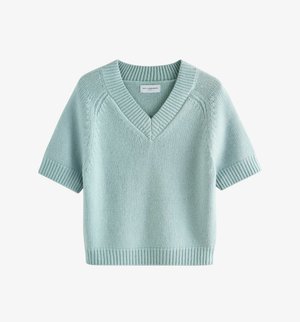 Light blue short-sleeve sweater in a soft knit. Features a V-neck, ribbed edges, and a relaxed fit with a smooth texture. 100% lambswool.