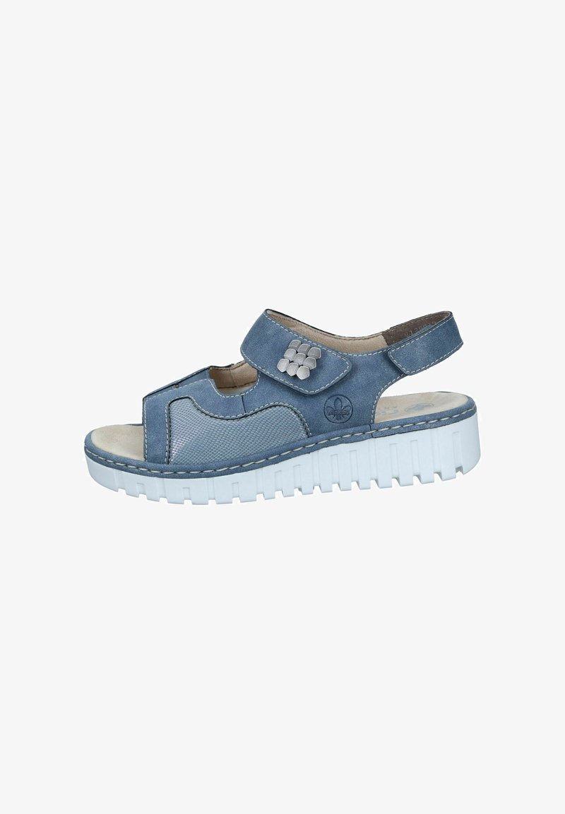 Blue sandal with a textured upper, adjustable strap, and decorative silver accents. Features a white, chunky sole for added comfort.
