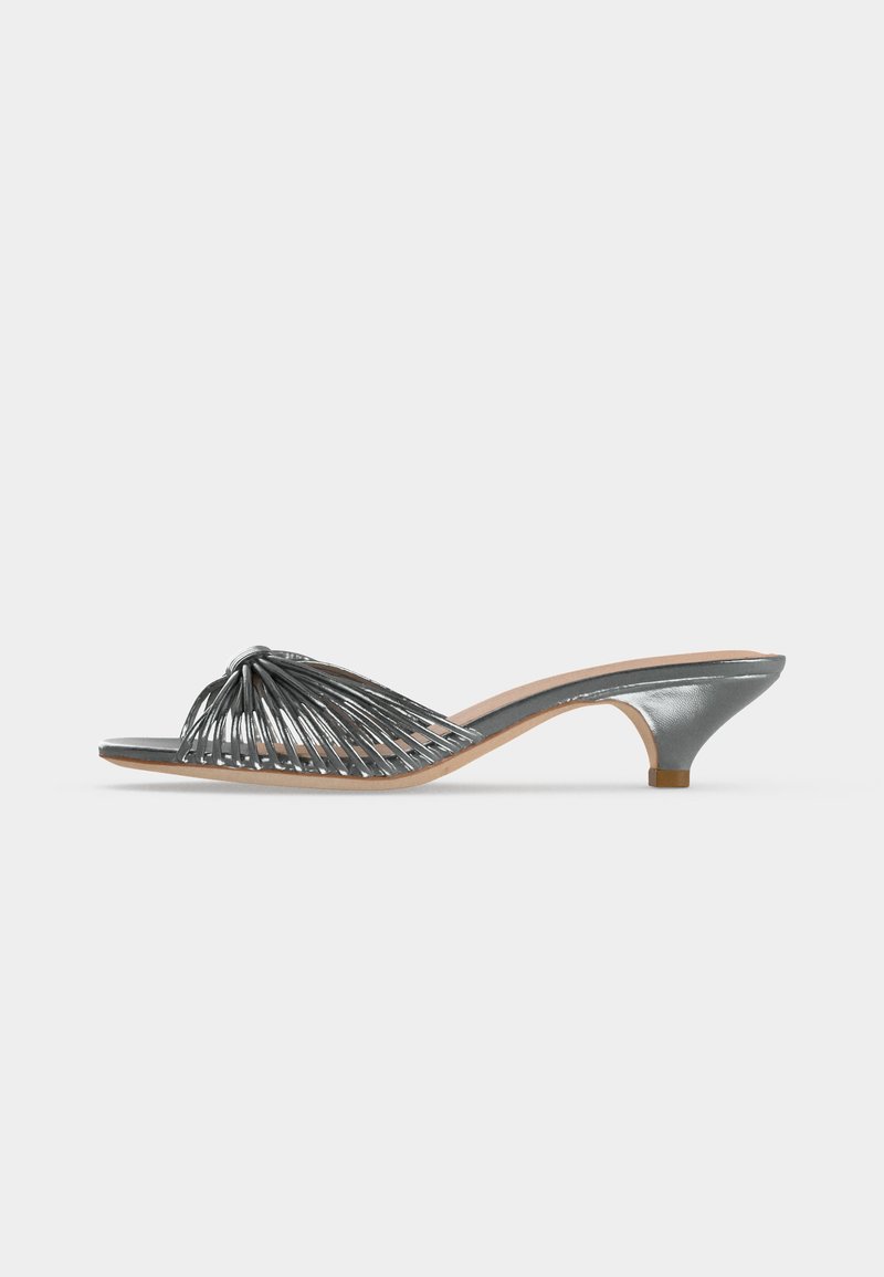 Metallic silver open-toe mule with low kitten heel and multiple thin straps forming a woven design across the foot.