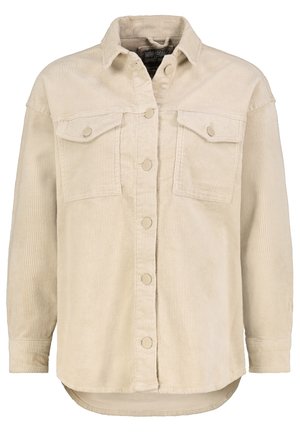Beige fløjlsjakke med knapper foran, to brystlommer med klapper, lange ærmer, krave og en let buet kant.