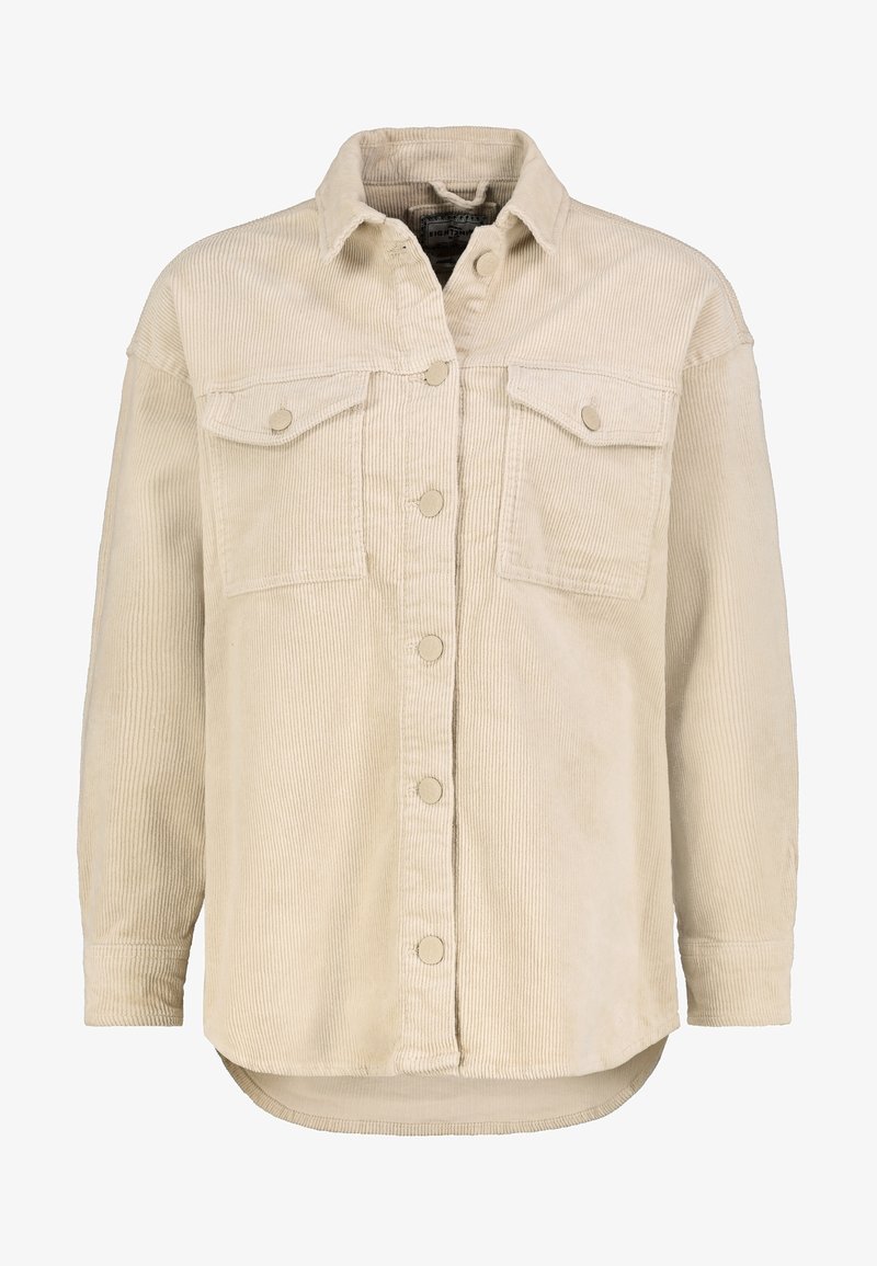 Veste beige en velours côtelé à boutons, avec deux poches à rabat sur la poitrine, manches longues, col et ourlet légèrement arrondi.