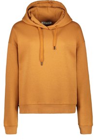 Orange bomullshuvtröja med dragsko, ribbade muddar och nederkant. Slät textur och en avslappnad passform med en känguruficka.
