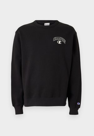 Črna majica s kapuco iz mešanice bombaža, z okroglim ovratnikom, rebrastimi manšetami in belim logotipom "Champion" spredaj.