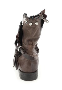 Brown leather ankle boot with decorative black beads and metal accents, featuring a rear zipper and textured finish on the surface.