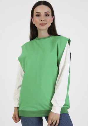 Felpa verde oversize con maniche lunghe bianche; realizzata in misto cotone; presenta un colletto rotondo e orlo a coste.