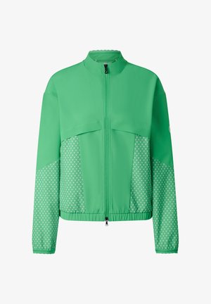 Grøn lynlåstrøje med mønstrede meshpaneler på ærmer og sider, elastisk kant og høj krave.