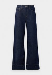 Mørkeblå vide denimjeans. Har knappestengning, sømdetaljer og sidelommer. Utskåret bunnsøm.