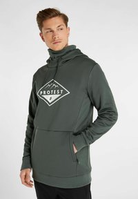 Felpa verde scura con colletto alto, grande tasca frontale e logo di montagna bianco. Texture liscia e design aderente.