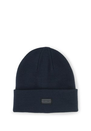 Dark blue knit beanie with a folded brim and a small rectangular label reading "Denim Design Studio" on the front.