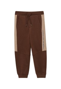 Braune Jogginghosen mit strukturierter Oberfläche, beige Seitenstreifen und Kordelzug am Bund. Mit seitlichem Aufdruck versehen.