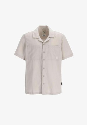 Korte mouwen, lichtbeige shirt gemaakt van zachte stof. Heeft een spreidkraag, twee voorzakken en een subtiele logo-label aan de zijkant.