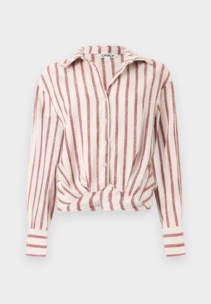 Fehér, hosszú ujjú, gombos blúz függőleges piros csíkokkal, elől csomós részlettel, gallérral és mandzsettás ujjak.