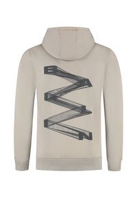 Beige hoodie met een vaste capuchon en een zwart geometrisch tekstontwerp dat het woord "BALAN" op de achterkant vormt.