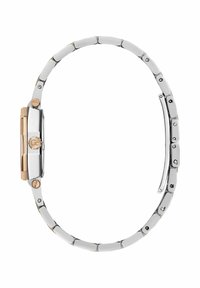 Suds un zelta tonēta metāla pulkstenis ar taisnstūra seju, saistītu siksniņu un apaļu kroni, kurā ir logotipa detalizācija malā.