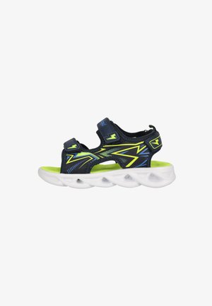Schwarze und neon-grüne Sportsandalen mit verstellbaren Riemen, ausgestattet mit einem Mesh-Obermaterial und einer weißen, gepolsterten Sohle mit sichtbaren Luftpolstern.