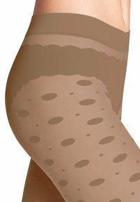 Collant trasparenti a fantasia di colore beige con un design a pois. Texture liscia con una vita resistente e finitura senza cuciture.