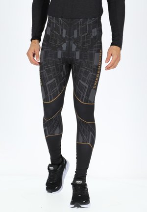 Zwarte sportleggings met een geometrisch patroon, voorzien van gouden accenten en een strakke pasvorm voor atletisch gebruik.