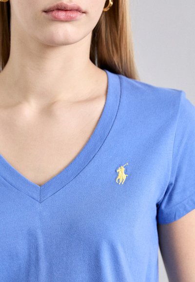 Blue v-neck t-shirt made of soft fabric, featuring a small yellow embroidered polo player logo on the left chest.