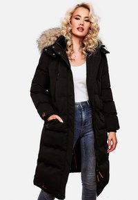 Black long puffer coat with a fur-lined hood, zippered front, and side pockets, featuring a quilted texture and contrasting red interior.